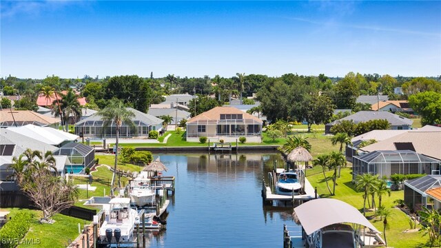 2010 SE 13th Ter, Cape Coral, FL 33990 - dock featuring boat lift, a residential view, and a water view