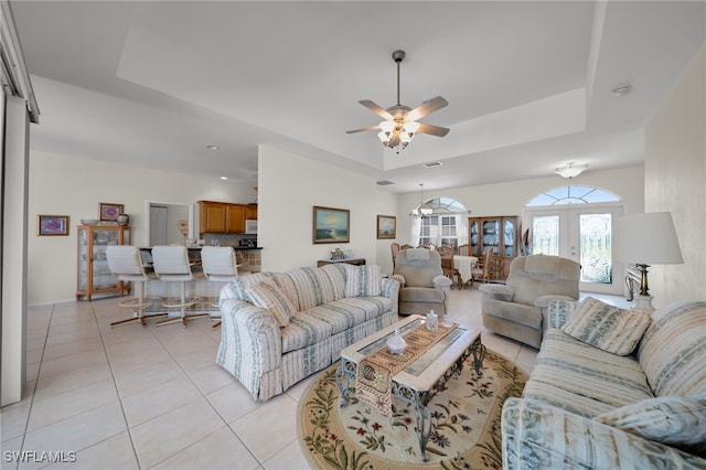 2010 SE 13th Ter, Cape Coral, FL 33990 - living room with a tray ceiling, ceiling fan, light tile patterned floors, and french doors