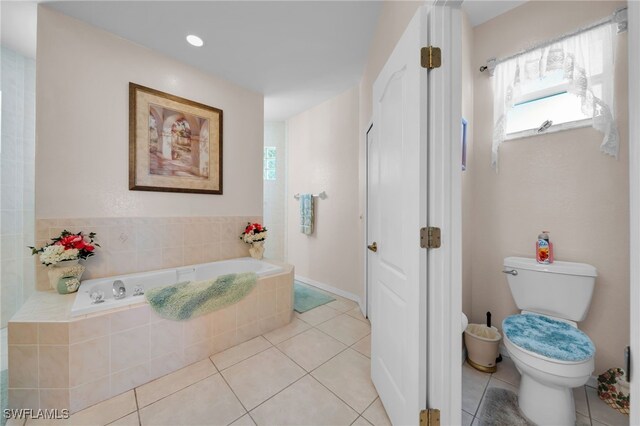 2010 SE 13th Ter, Cape Coral, FL 33990 - bathroom featuring a bath, toilet, and tile patterned floors