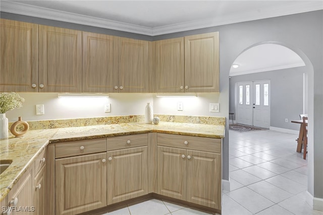 6700 Eagle Tree Ct, North Fort Myers, FL 33917 - kitchen featuring arched walkways, ornamental molding, light tile patterned floors, light brown cabinetry, and light stone counters