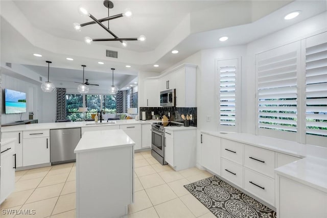10220 Bellavista Cir Unit 1402, Miromar Lakes, FL 33913 - kitchen featuring stainless steel appliances, a sink, tasteful backsplash, a center island, and pendant lighting