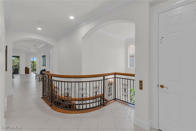 9142 Cherry Oaks Ln Unit 202, Naples, FL 34114 - corridor with arched walkways, an upstairs landing, light tile patterned floors, baseboards, and recessed lighting