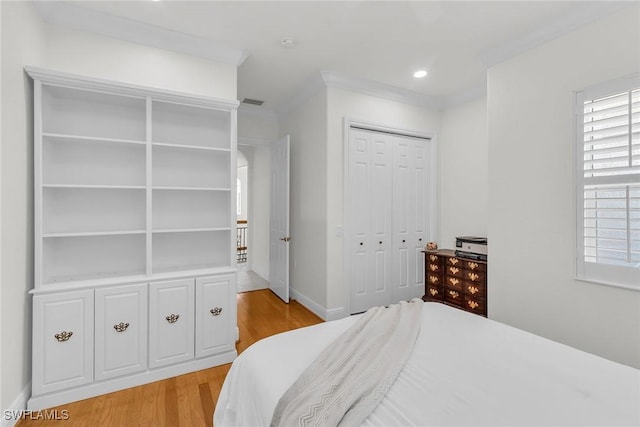 9142 Cherry Oaks Ln Unit 202, Naples, FL 34114 - bedroom featuring light wood finished floors, multiple windows, crown molding, a closet, and baseboards