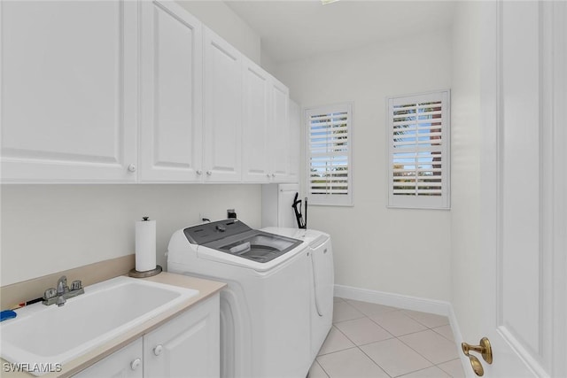 9142 Cherry Oaks Ln Unit 202, Naples, FL 34114 - laundry area featuring washer and clothes dryer, cabinet space, light tile patterned floors, and baseboards
