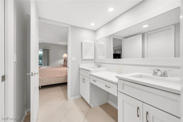 1020 Swallow Ave Unit 102, Marco Island, FL 34145 - ensuite bathroom featuring double vanity, recessed lighting, tile patterned floors, and baseboards