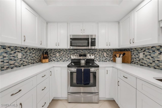 1020 Swallow Ave Unit 102, Marco Island, FL 34145 - kitchen with stainless steel appliances, white cabinetry, and light countertops