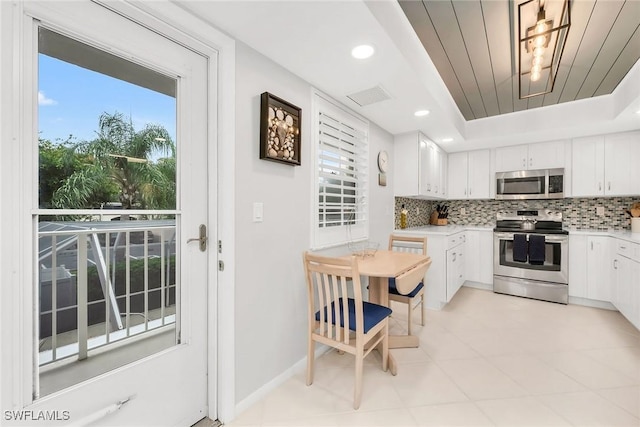 1020 Swallow Ave Unit 102, Marco Island, FL 34145 - kitchen featuring appliances with stainless steel finishes, decorative backsplash, plenty of natural light, light countertops, and recessed lighting