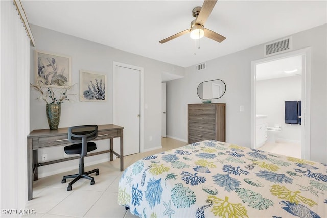 1020 Swallow Ave Unit 102, Marco Island, FL 34145 - bedroom with a desk, light tile patterned floors, connected bathroom, and ceiling fan
