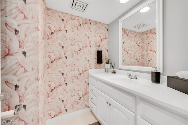 1020 Swallow Ave Unit 102, Marco Island, FL 34145 - bathroom with vanity and wallpapered walls