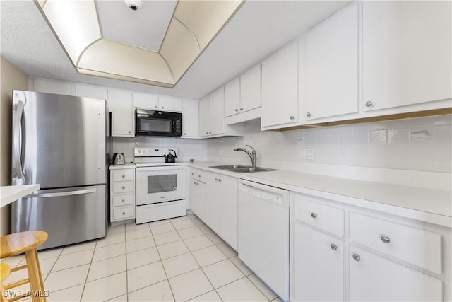 6612 Estero Blvd Unit Ph2, Fort Myers Beach, FL 33931 - kitchen featuring white appliances, a sink, white cabinets, light countertops, and light tile patterned floors