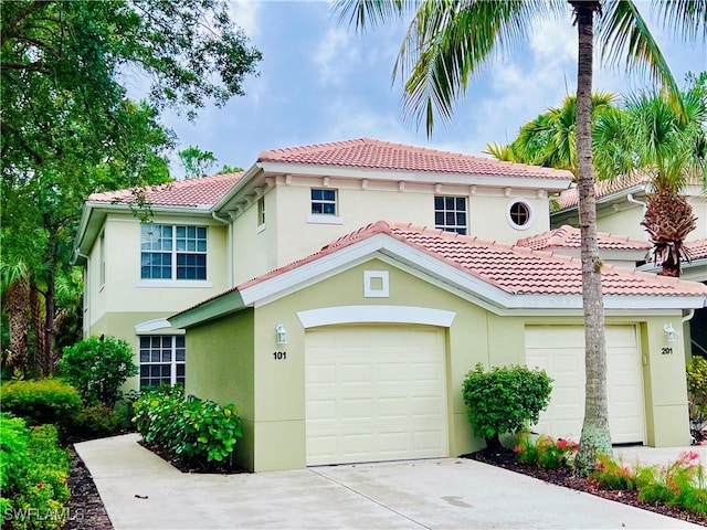 1732 Tarpon Bay Dr S Unit 101, Naples, FL 34119 - mediterranean / spanish-style house featuring stucco siding, concrete driveway, a garage, and a tile roof