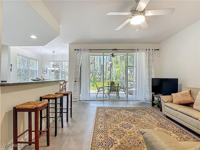 1732 Tarpon Bay Dr S Unit 101, Naples, FL 34119 - living room with healthy amount of natural light, ceiling fan, light tile patterned floors, and recessed lighting