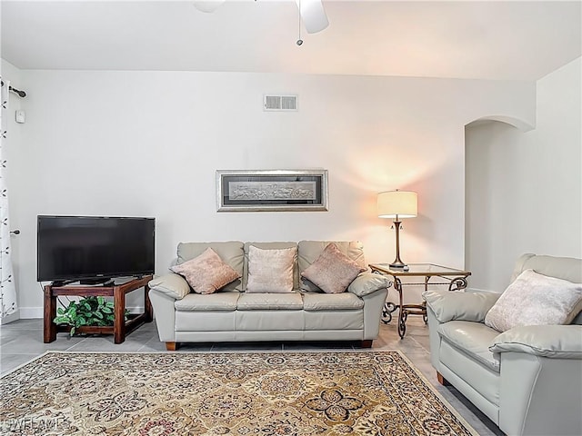 1732 Tarpon Bay Dr S Unit 101, Naples, FL 34119 - living room with arched walkways, a ceiling fan, and baseboards