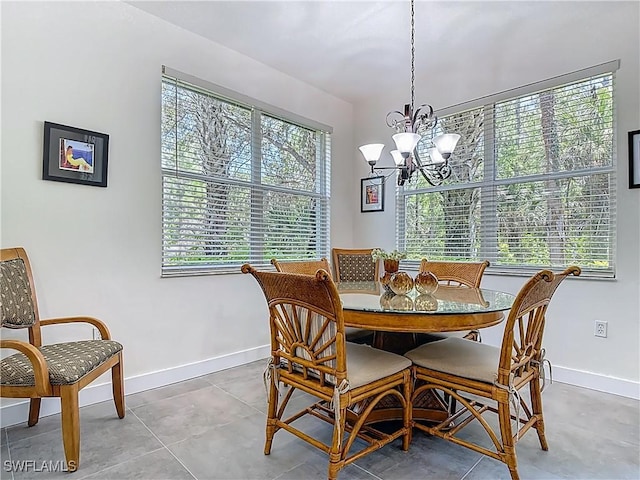 1732 Tarpon Bay Dr S Unit 101, Naples, FL 34119 - dining area featuring a chandelier and baseboards