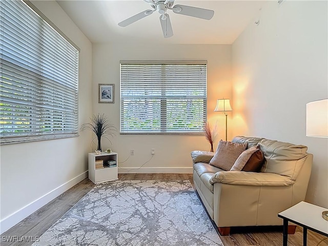 1732 Tarpon Bay Dr S Unit 101, Naples, FL 34119 - living area featuring a ceiling fan, wood finished floors, and baseboards