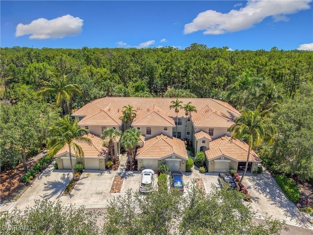 1732 Tarpon Bay Dr S Unit 101, Naples, FL 34119 - aerial view of property and surrounding area with a heavily wooded area