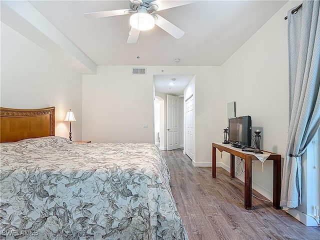 1732 Tarpon Bay Dr S Unit 101, Naples, FL 34119 - bedroom featuring wood finished floors, a ceiling fan, and baseboards