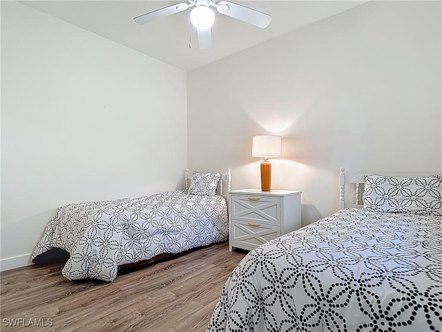 1732 Tarpon Bay Dr S Unit 101, Naples, FL 34119 - bedroom with wood finished floors, a ceiling fan, and baseboards