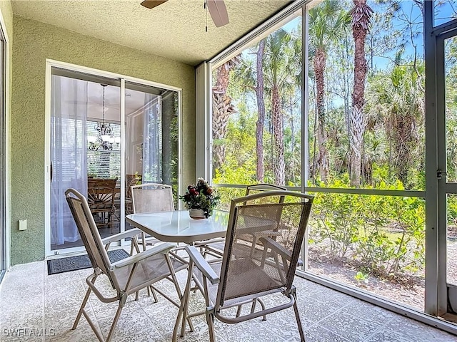 1732 Tarpon Bay Dr S Unit 101, Naples, FL 34119 - sunroom with a textured wall, a ceiling fan, and a textured ceiling