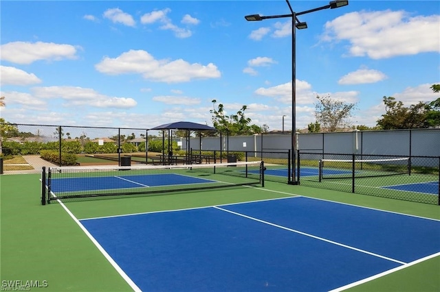 309 Spiaggio Ct, Naples, FL 34114 - view of tennis court with fence and community basketball court