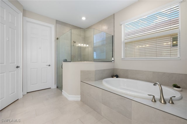 309 Spiaggio Ct, Naples, FL 34114 - bathroom with a stall shower, a bath, tile patterned floors, and baseboards