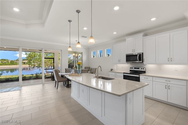 309 Spiaggio Ct, Naples, FL 34114 - kitchen featuring stainless steel appliances, a sink, decorative backsplash, a center island with sink, and white cabinetry