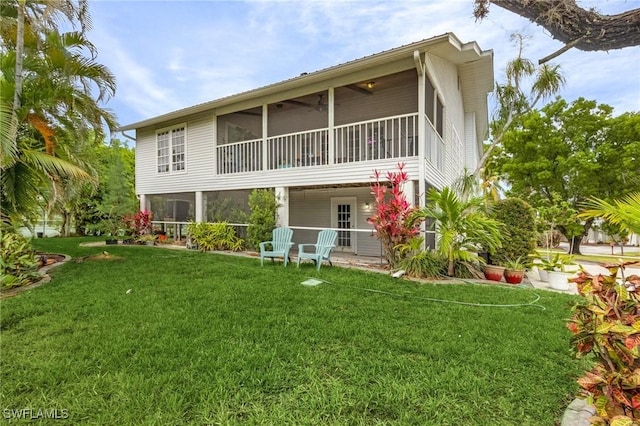 7269 Heaven Ln, Fort Myers, FL 33908 - back of house with a sunroom and a lawn