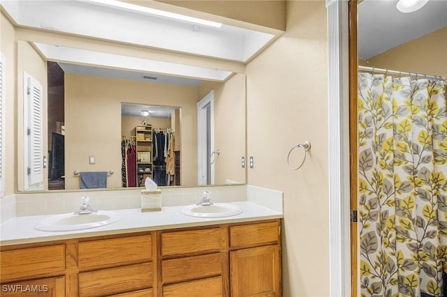 7269 Heaven Ln, Fort Myers, FL 33908 - bathroom featuring double vanity, a walk in closet, and curtained shower