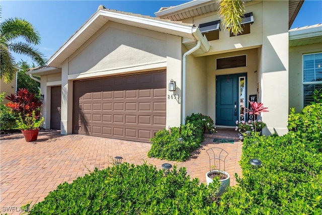 8651 Colony Trace Dr, Fort Myers, FL 33908 - multi unit property with stucco siding, a garage, and decorative driveway
