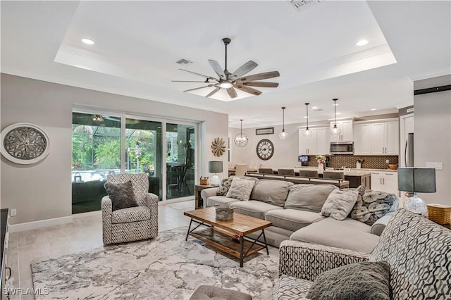 8651 Colony Trace Dr, Fort Myers, FL 33908 - living room featuring a ceiling fan, a tray ceiling, recessed lighting, baseboards, and crown molding