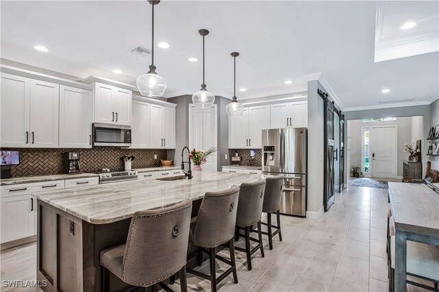 8651 Colony Trace Dr, Fort Myers, FL 33908 - kitchen with appliances with stainless steel finishes, a sink, ornamental molding, decorative backsplash, and recessed lighting