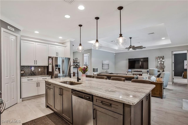 8651 Colony Trace Dr, Fort Myers, FL 33908 - kitchen featuring appliances with stainless steel finishes, a sink, crown molding, ceiling fan, and white cabinetry