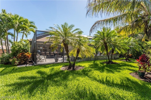 8651 Colony Trace Dr, Fort Myers, FL 33908 - view of green lawn featuring a patio and glass enclosure