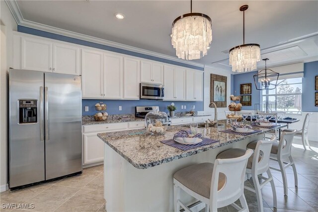 10871 Rose Quartz Ln, North Fort Myers, FL 33917 - kitchen featuring appliances with stainless steel finishes, a sink, a chandelier, white cabinetry, and ornamental molding