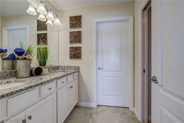 10871 Rose Quartz Ln, North Fort Myers, FL 33917 - full bathroom featuring double vanity, tile patterned floors, baseboards, and a chandelier