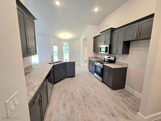 2201 Como St, Port Charlotte, FL 33948 - kitchen with appliances with stainless steel finishes, a sink, a peninsula, baseboards, and recessed lighting