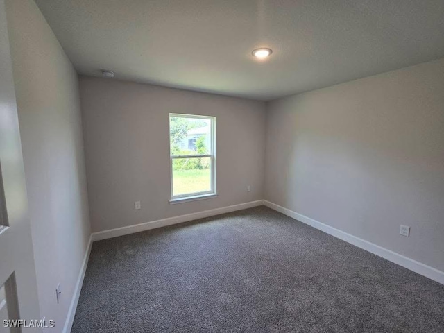 2201 Como St, Port Charlotte, FL 33948 - carpeted spare room featuring baseboards and a smoke detector