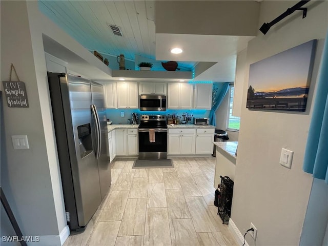 17133 Phlox Dr, Fort Myers, FL 33967 - kitchen with stainless steel appliances, light countertops, white cabinetry, and recessed lighting