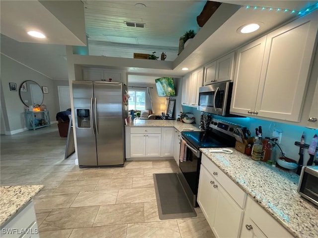 17133 Phlox Dr, Fort Myers, FL 33967 - kitchen with stainless steel appliances, light stone counters, and baseboards