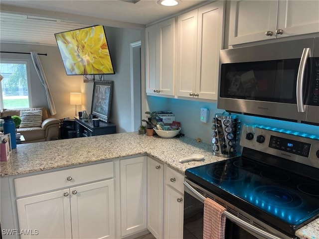 17133 Phlox Dr, Fort Myers, FL 33967 - kitchen with appliances with stainless steel finishes, white cabinets, and light stone countertops