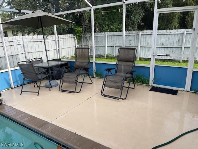 17133 Phlox Dr, Fort Myers, FL 33967 - view of patio / terrace featuring a fenced backyard, a lanai, and outdoor dining area