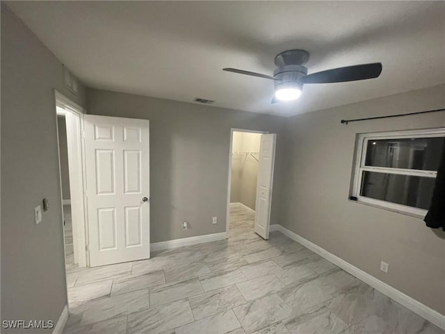 17133 Phlox Dr, Fort Myers, FL 33967 - unfurnished bedroom featuring marble finish floors, baseboards, a closet, ceiling fan, and a spacious closet