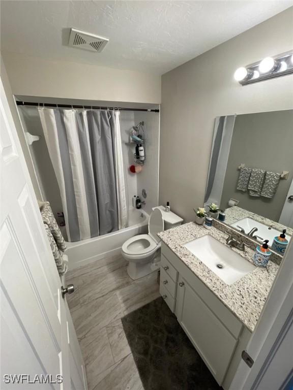 17133 Phlox Dr, Fort Myers, FL 33967 - full bathroom with shower / tub combo with curtain, toilet, and vanity