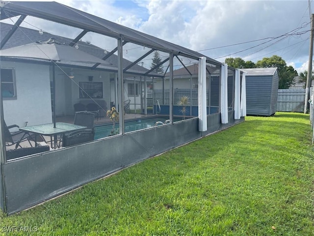 17133 Phlox Dr, Fort Myers, FL 33967 - view of yard featuring a storage unit, an outdoor structure, and glass enclosure