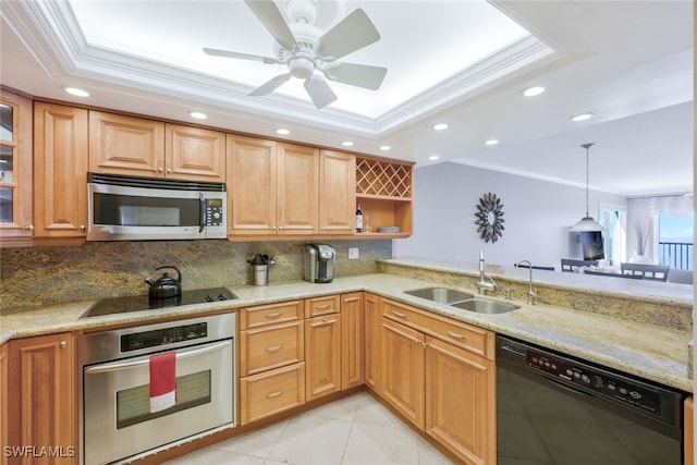 kitchen with black appliances, a sink, ornamental molding, a raised ceiling, and backsplash