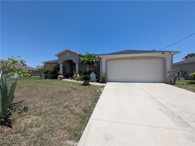 1711 NW 28th Ter, Cape Coral, FL 33993 - view of front of home featuring driveway, an attached garage, and stucco siding