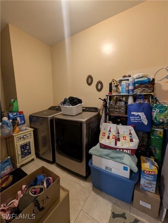 1711 NW 28th Ter, Cape Coral, FL 33993 - washroom with separate washer and dryer and light tile patterned flooring