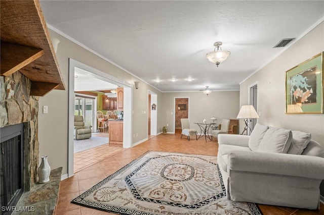 1263 Caloosa Dr, Fort Myers, FL 33901 - living area featuring ornamental molding, light tile patterned floors, a stone fireplace, and baseboards