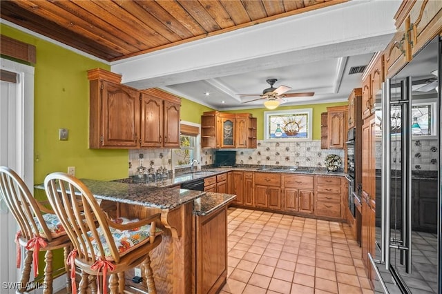 1263 Caloosa Dr, Fort Myers, FL 33901 - kitchen featuring a peninsula, brown cabinets, open shelves, a kitchen breakfast bar, and ornamental molding