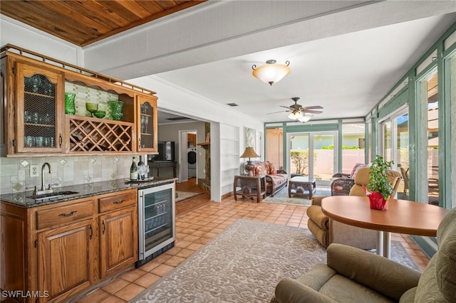 1263 Caloosa Dr, Fort Myers, FL 33901 - indoor wet bar featuring beverage cooler, light tile patterned flooring, decorative backsplash, and a ceiling fan